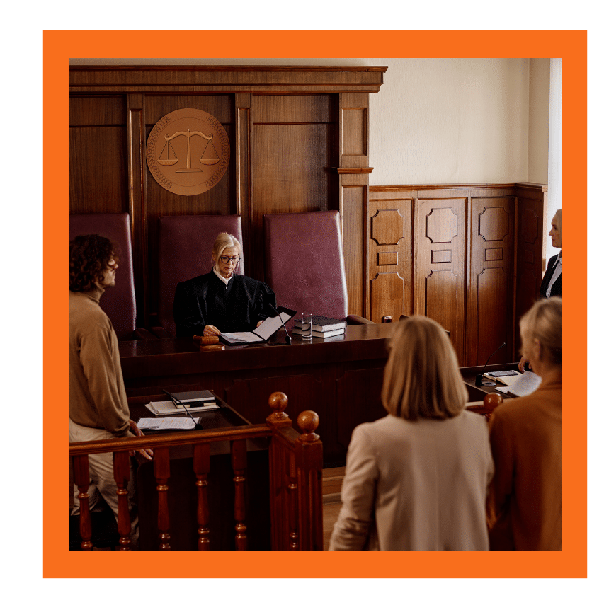 Judge overseeing a hearing with attorneys and individuals in a courtroom