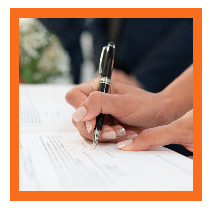 Person signing legal paperwork with a pen